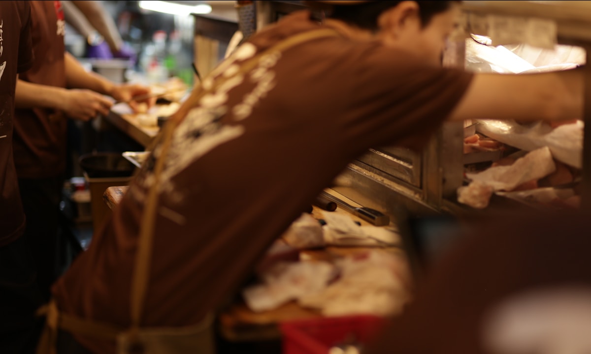 Chef preparing food behind a restaurant counter